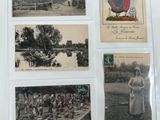 an old photo of a bunch of old postcards on a table