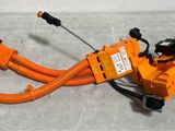 a close up of an orange hose connected to a power cord