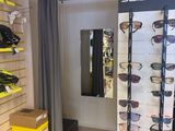 many pairs of sunglasses on display in a store