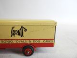 a red and yellow toy truck with a sign on it