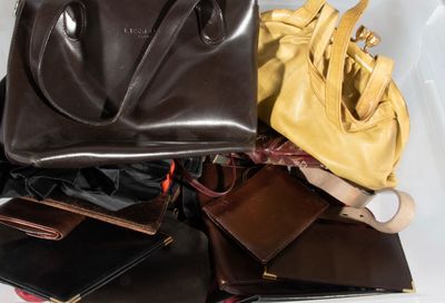 many bags and purses that are sitting on a table
