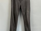 un pantalon gris accroché à un mur blanc