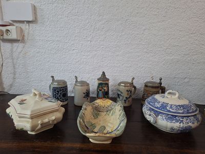 many different types of pottery sitting on a table