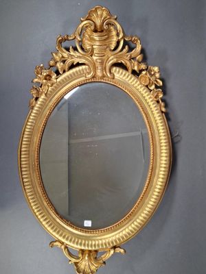 a gold mirror on the wall in the room