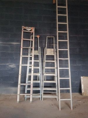 three ladders that are leaning against a wall