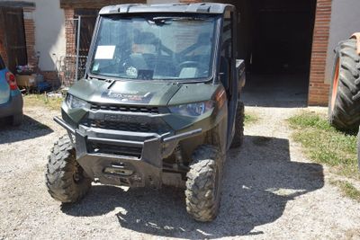 an image of a utility vehicle parked in front of a house