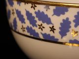 close up of a blue and white bowl on a black surface