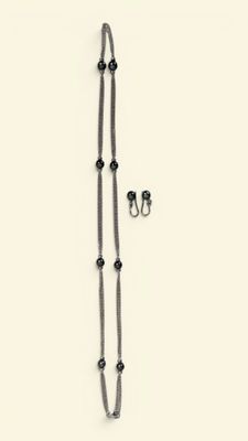 a necklace and earring set on a white surface