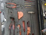 someone is holding a tool box with many different tools in it