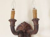 two wall sconces that are attached to the wall