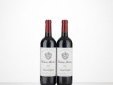 two bottles of wine sitting on top of a table next to each other