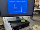 a computer monitor sitting on top of a desk next to a keyboard and mouse