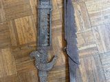 pair of old iron door handles on a wooden floor