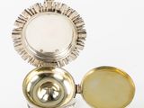 an image of a small silver box with a mirror on top