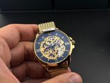 a close up of a person holding a watch in their hand