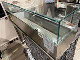 a man standing in front of a glass display case