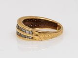 a close up of a gold ring with diamonds on a white surface