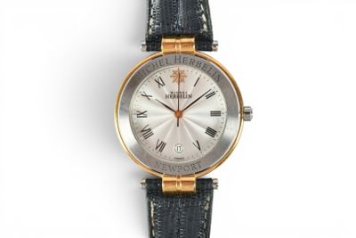 a close up of a wrist watch with roman numerals on it