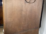 a wooden cabinet with a metal handle on top of it