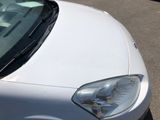 a white car that is parked on the side of the road