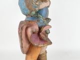 an image of a figurine of a man sitting on top of a mushroom