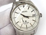 a close up of a person holding a wrist watch