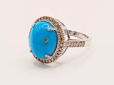 a turquoise turquoise stone and diamond ring on a white background