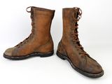 pair of brown leather boots with laces on them on a white background