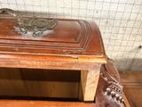 a small wooden table with a bird on top of it