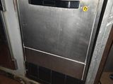 a stainless steel dishwasher in the middle of a kitchen