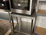 an oven that is sitting on a stand in a room