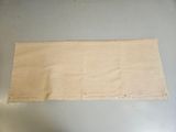 a piece of cloth on the floor next to a pair of scissors