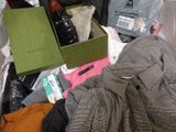 a pile of clothes and other items on the floor