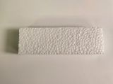 a close up of a piece of white paper on a white surface