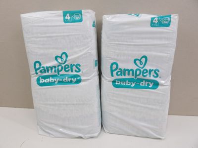 two packs of pampers baby dry diapers sitting on top of each other