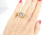 an image of a woman ' s hand with a red manicure holding a diamond ring