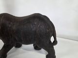 wooden rhino figurine on white background with white backdrop