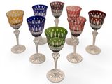 several different colored glass goblets sitting on top of each other