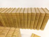 a lot of books that are stacked on top of each other