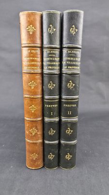 three old books sitting on top of each other on a table
