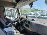 a view of the inside of a truck from the driver ' s seat