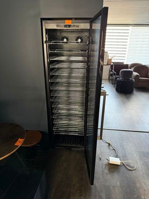 an image of a room with a refrigerator and a table