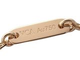 a close up of a gold bracelet with a tag on it