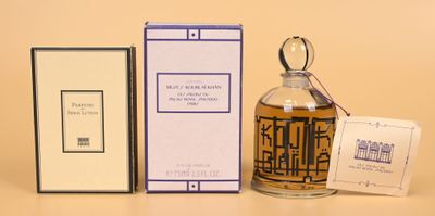 a bottle of perfume sitting next to a box