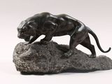 statue of a panther on a rock on a white background