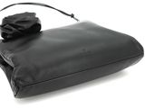 a black purse with a bow on top of it