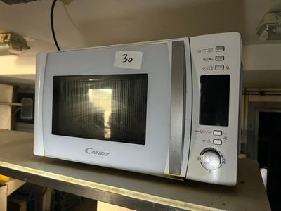 un micro-ondes posé sur une étagère dans la cuisine