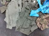 many different types of military clothing on the floor