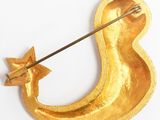 gold crescent shaped brooch with a star on top of it