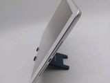 the back of a tablet computer sitting on top of a white table